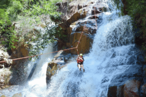 Abseiling down a waterfall while canyoning in Da Lat, Central Highlands of Vietnam
