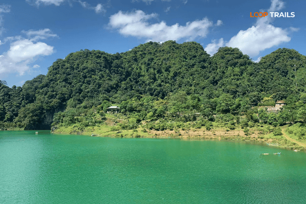 Kayaking on Thang Hen Lake below limestone cliffs in Tra Linh, Cao Bang