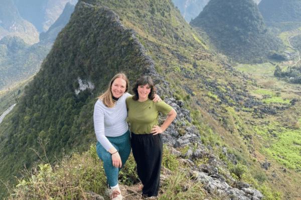 2 customers take photos on the top of mountain on ha giang loop