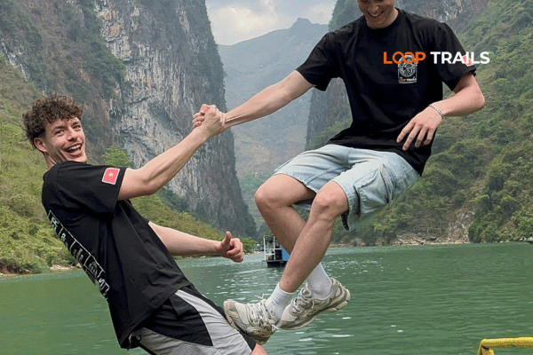 2 guys of looptrails on boat trip in nho que river