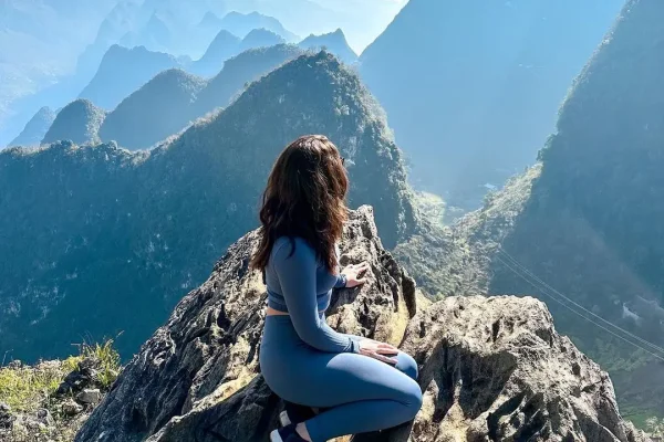a girl doing the ha giang loop in sunny day