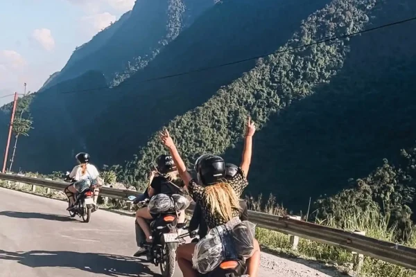 Motorbike packed for Ha Giang Loop with backpack secured to rear rack at Ma Pi Leng Pass