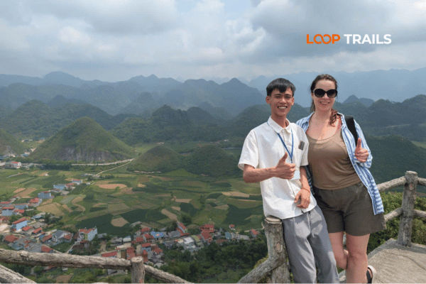 a tourist and a guide in quan ba twins mountain