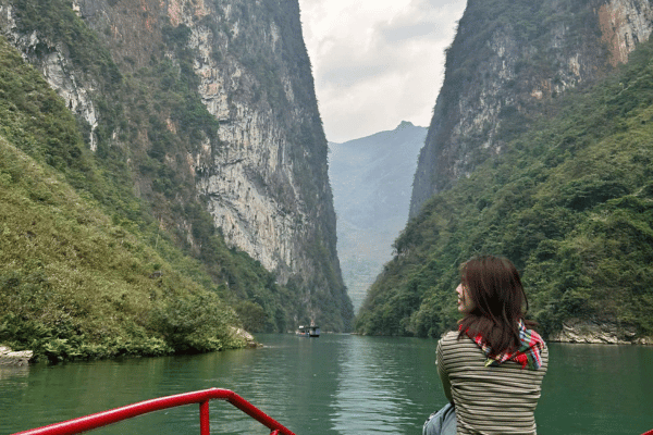 a tourist on a boat trip in nho que river