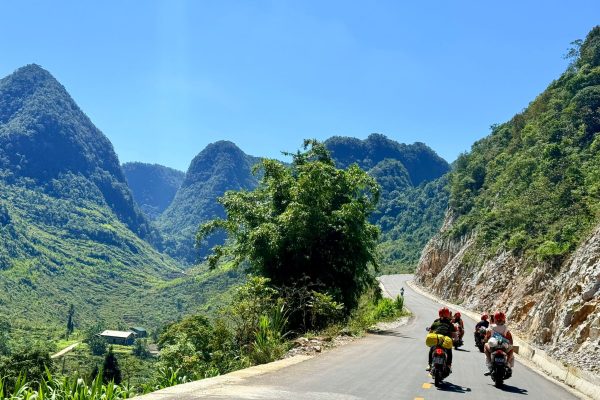 Motorcycle rider on Ma Pi Leng Pass during Ha Giang Loop self-drive tour with Ma Pi Leng Pass views