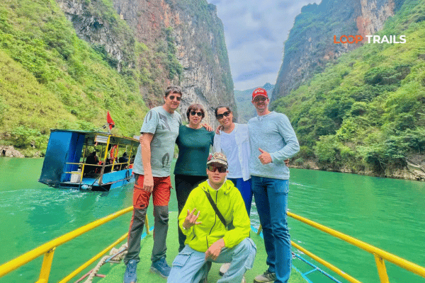 customers of looptrails on a boat trip in nho que river