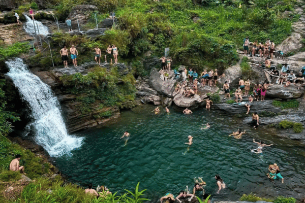 Du Gia Waterfall swimming pool on Ha Giang Loop with travelers cooling off in mountain water