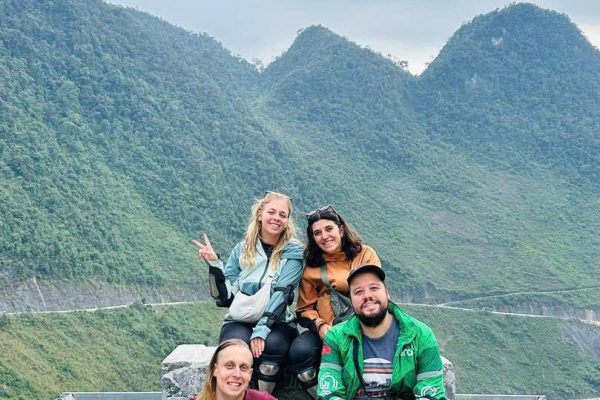 Group of travelers on easy rider motorbike tour through Ha Giang mountain valleys
