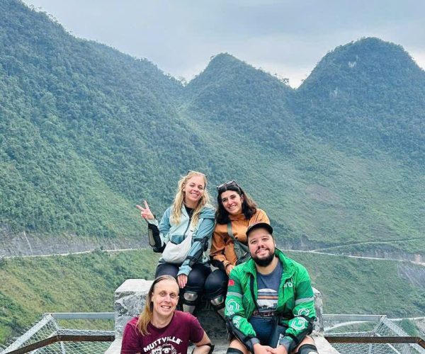 Group of travelers on easy rider motorbike tour through Ha Giang mountain valleys