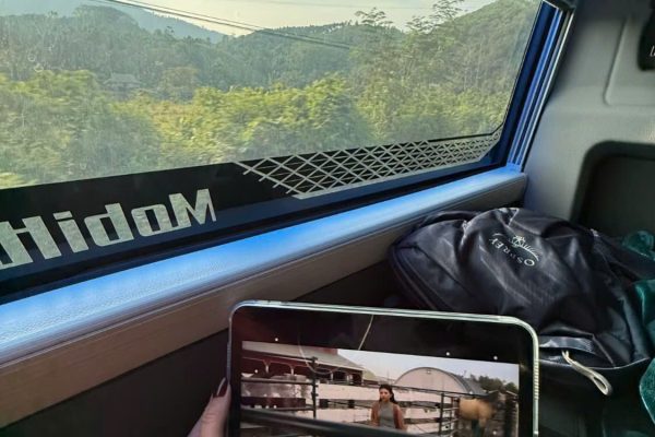 VIP sleeper bus on mountain road to Ha Giang with limestone karst peaks