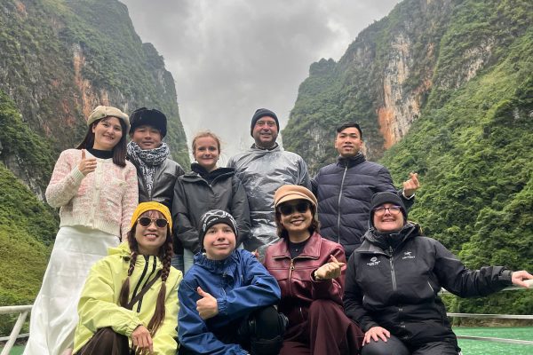 tourist on a boat of nho que river with ha giang loop trails