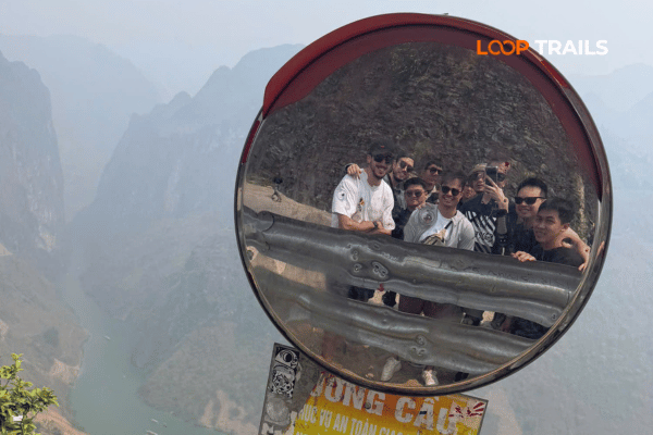 take photos in convex mirror with nho que river view Ha Giang Loop Last-Minute Booking
