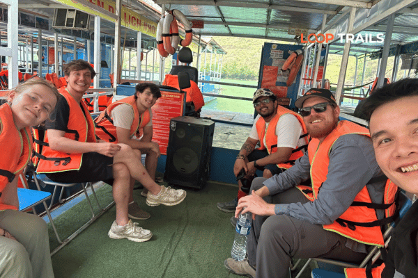 tourist of looptrails wearing life vest on a boat trip cao bang loop tour