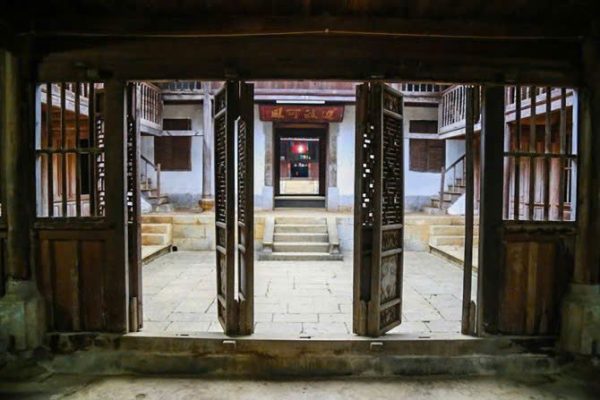 Main reception hall of Hmong King palace showing ancestor altar and period furniture